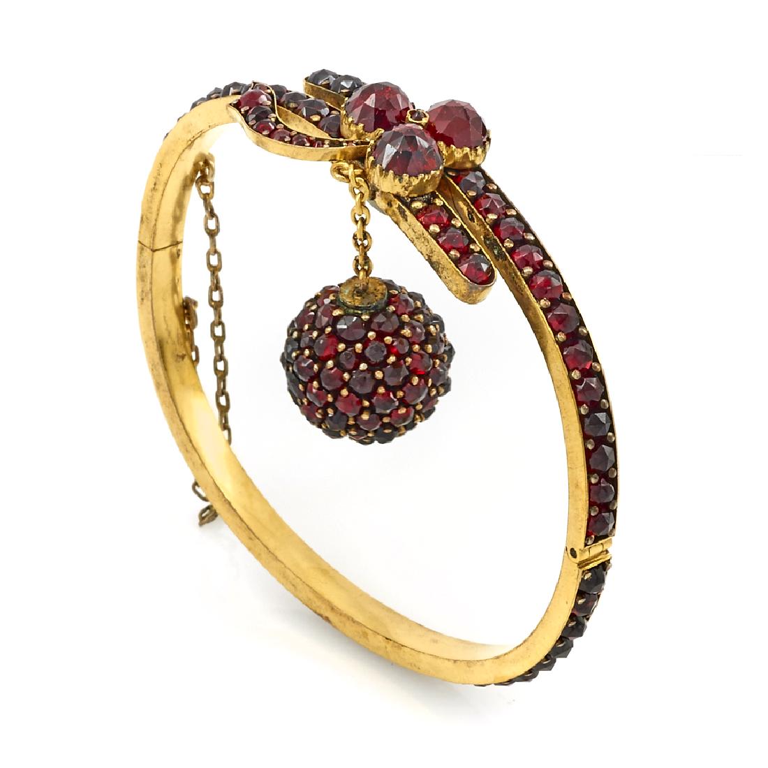 Victorian gilt and bohemian garnet hinged bangle. (1 of 1)