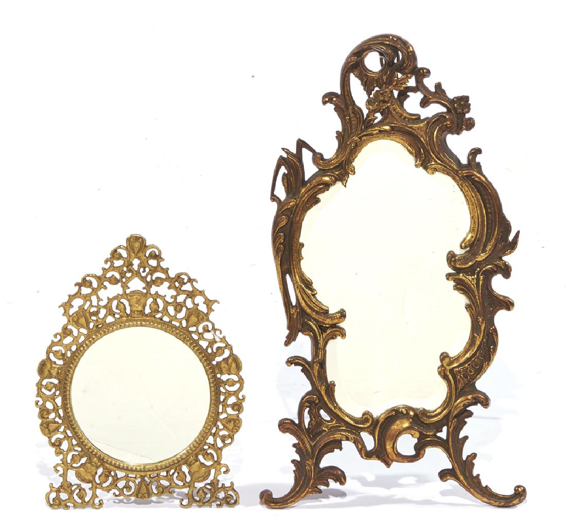 Two 19th c table mirrors: Two 19th c table mirrors including: Large bronze rococo framed mirror of shaped beveled glass, marked "NB&IW" (National Bronze and Iron Works), appx 22" t; Brass scrollwork framed round mirror, appx 1