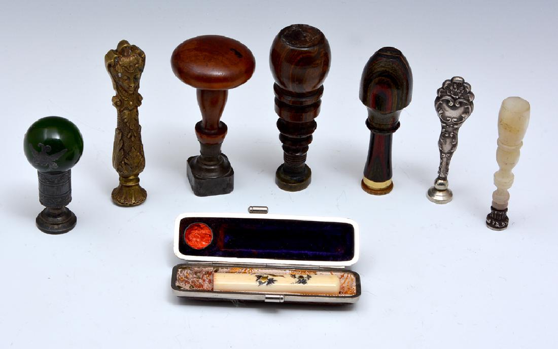 Eight wax stamp seals of metal, wood, stone: Eight wax stamp seals of metal, wood, stone, various ages, all with monograms, 2 with coats of arms, one Chinese seal in a fitted case, largest appx 3 1/2". Good condition.