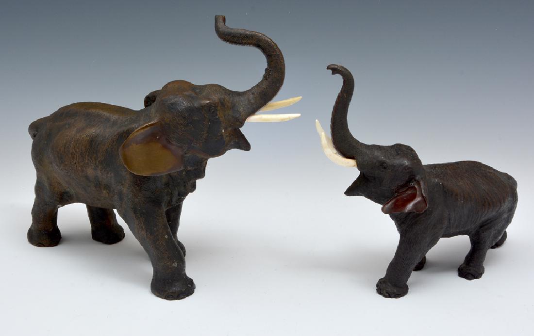 Grouping of two Japanese bronze elephants, largest 11": Grouping of two Japanese bronze elephants, trunks up, finely patinated, marked on bottom, largest appx 11" h. Very good condition, each elephant has one repaired tusk.