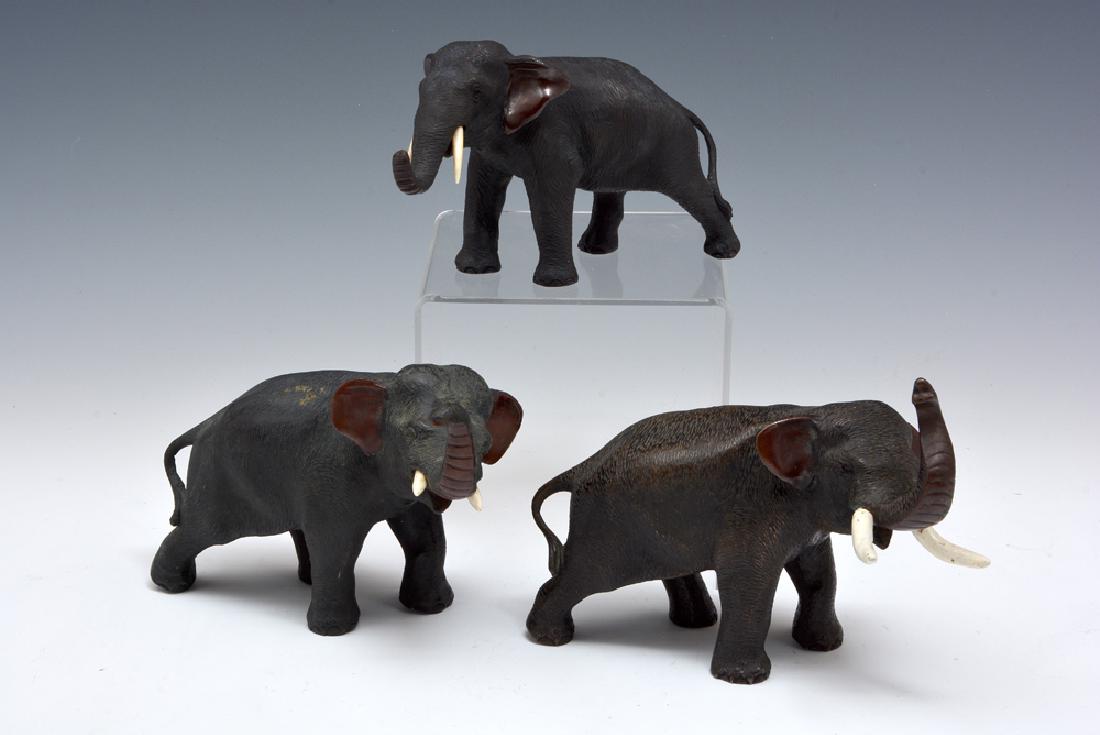 Grouping of three Japanese bronze elephants, largest 5": Grouping of three Japanese bronze elephants, two with trunks up, finely patinated, one marked on bottom, largest appx 5" t. Very good condition, one elephant has one repaired tusk.