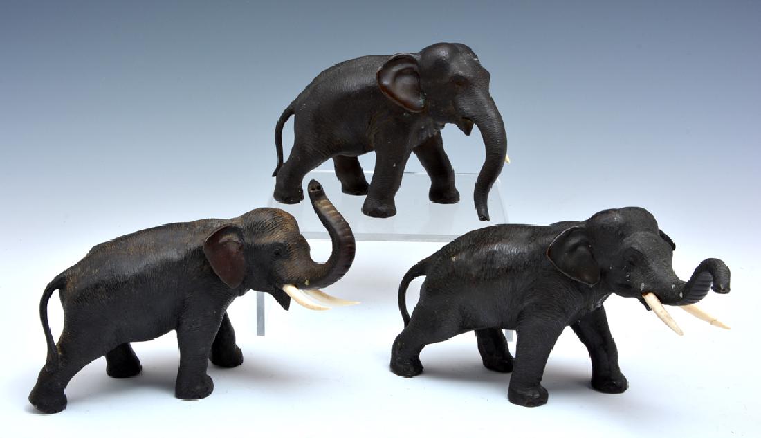 Grouping of three Japanese bronze elephants, 5 1/2" t: Grouping of three Japanese bronze elephants, two with trunks up, finely patinated, marked on bottom, largest appx 5 1/2" t. Very good condition, one elephant has one repaired tusk, one elephant missin