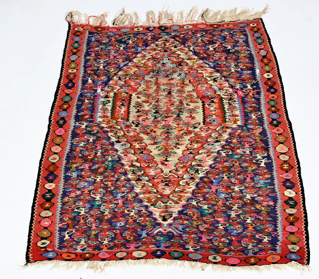 Flat weave textile rug with stylized animal head motif (1 of 2)