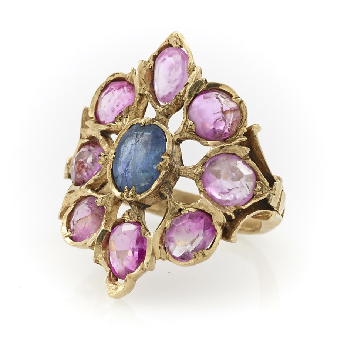 24k Yellow gold ruby and sapphire Mughal style ring: 24k Yellow gold ruby and sapphire Mughal style ring, a center sapphire appx 5mm x 6mm surrounded by eight 4.5mm rubies, size 4, 6.3g.