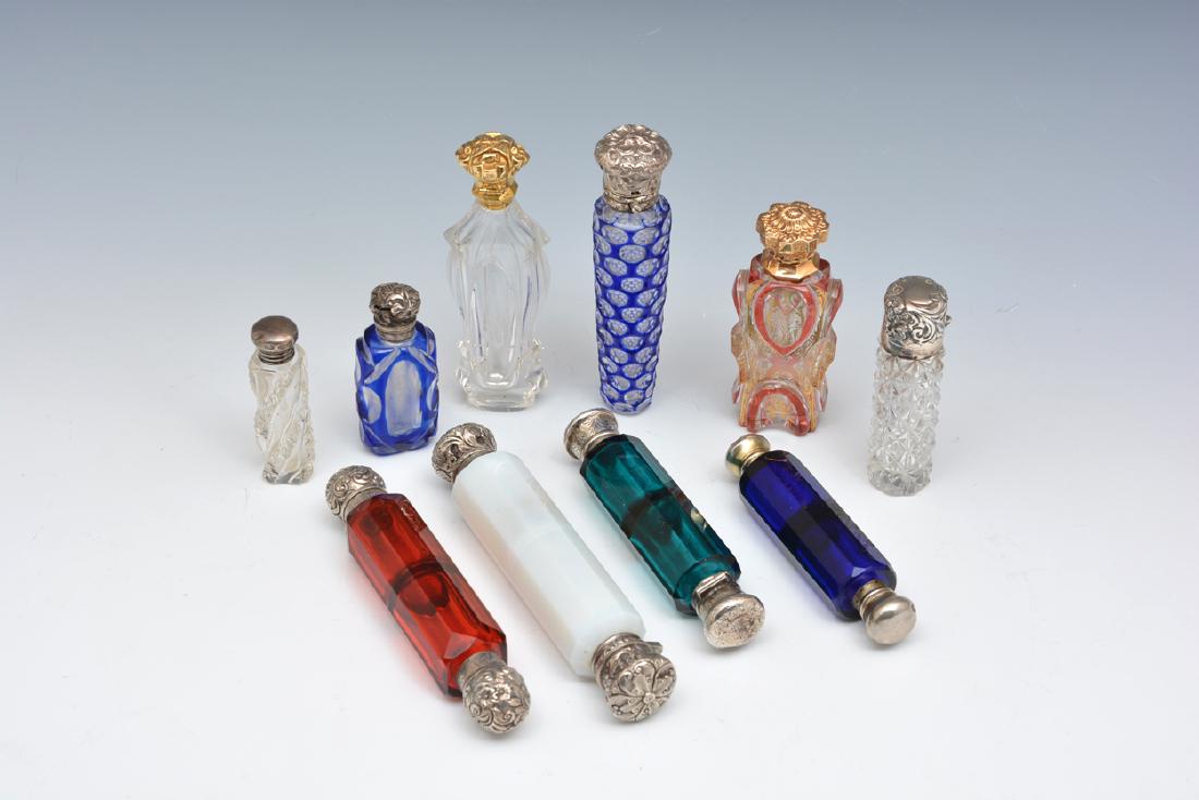 Grouping of 10 cut crystal perfumes: Grouping of 10 cut crystal perfumes, mostly sterling tops. Four of the perfumes are double ended, and six are standing. Lacking two stoppers. Longest measures appx 5 5/8".