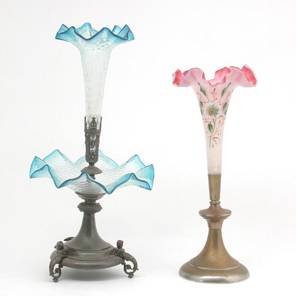 Two Victorian Glass Epergnes: EPERGNES. Two Victorian glass epergnes, 19th century. Lot consists of one tall satin glass epergne with floral decoration and one clear to blue glass epergne with silver-plate base and angel figural f