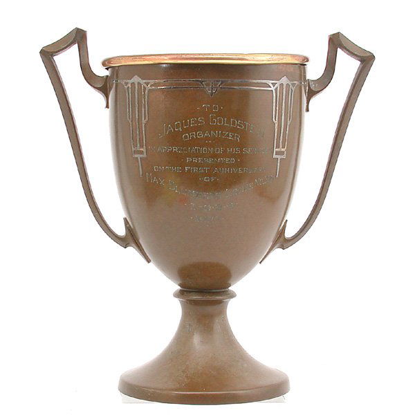Arts & Crafts Silver over Bronze Trophy by Silverc: TROPHY. Large Bronze Arts & Crafts silver over bronze trophy by Silvercrest, presented to Jaques Goldstein from the Max Blumberg Lodge 1927. Very good original condition. 11"w x 7"d x 12"h.