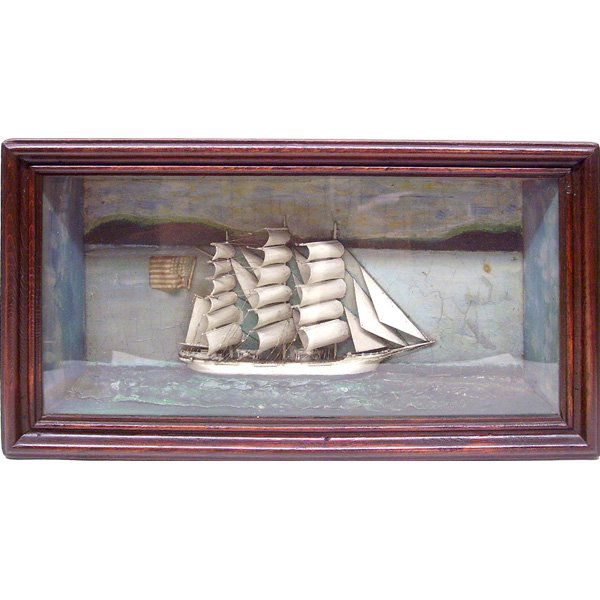 Ship Model Sailor Folk Art Shadow Box: MODEL. Early American sailor folk art shadow box of a 3 masted sailing ship. The ship is flying the American flag at the stern with painted background and sailing on a simulated sea. 13" X 23" overall