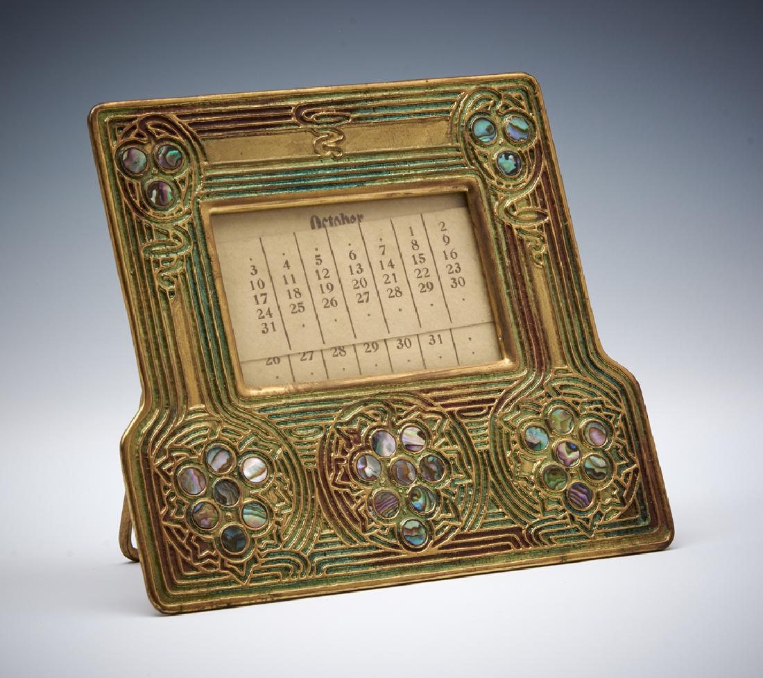 Tiffany gold dore Abalone perpetual calendar: Tiffany gold dore Abalone perpetual calendar marked "Tiffany Studios New York" and "1166", includes calendar inserts, appx 6 3/8" w x 5 3/4" t. Good condition.