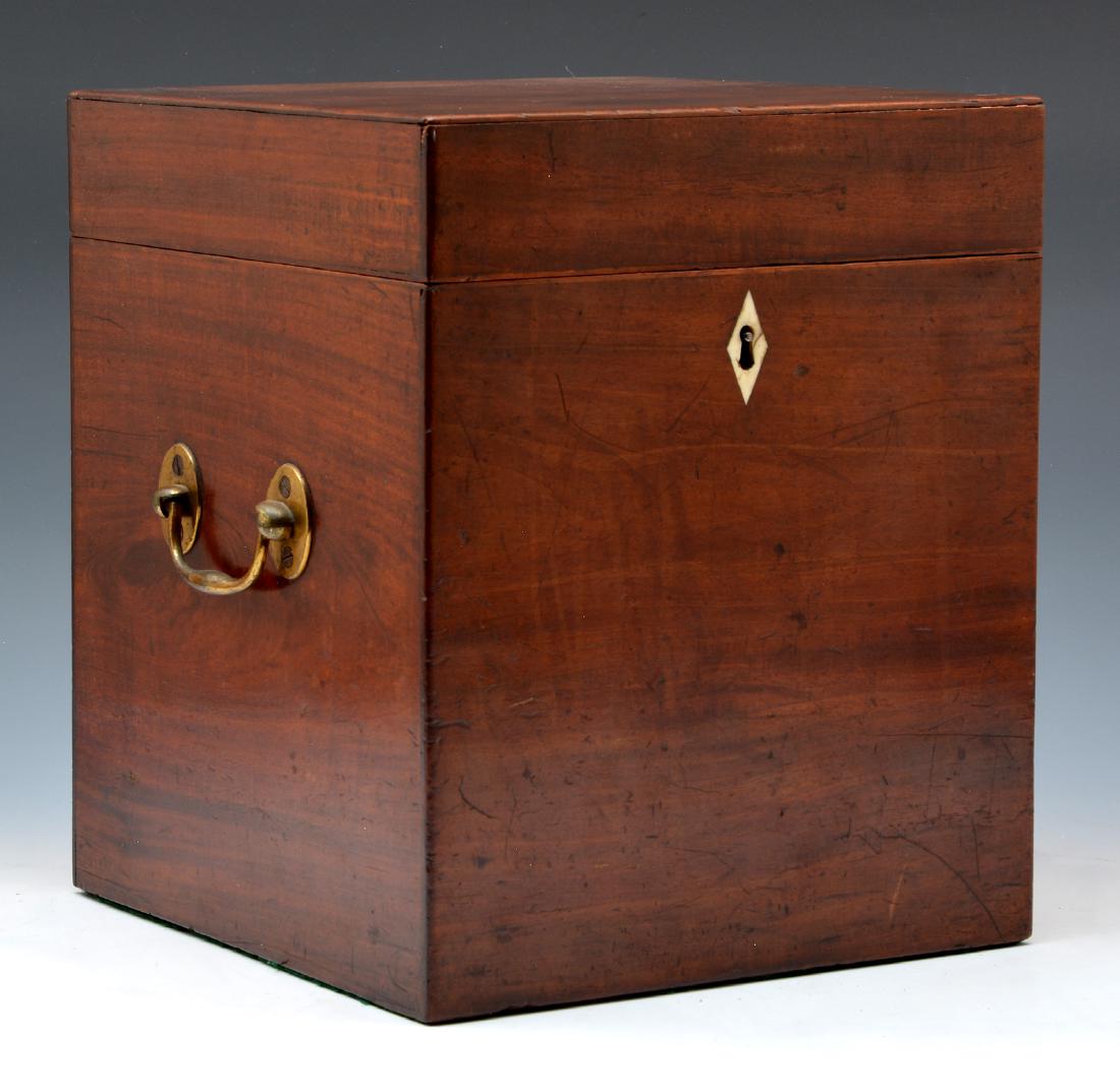 English Mahogany bottle caddy: English Mahogany bottle caddy with inlaid escutcheon, brass handles and felt lined. 12"t x 10"w x 10"d. Good condition