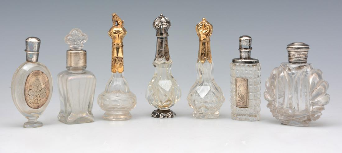 Grouping of 7 crystal perfumes with silver and gold (1 of 3)