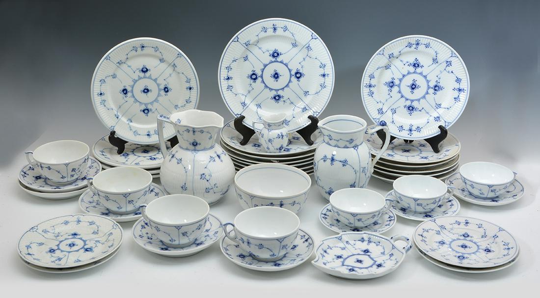 Royal Copenhagen Blue Fluted Dinnerware, 42 pieces.: Royal Copenhagen Blue Fluted Dinnerware. Largest plate: 9 1/4"; Tallest pitcher: 6 3/4" tall. Very good condition with some minor wear from use. Rim chip to pitcher. 42 pieces.