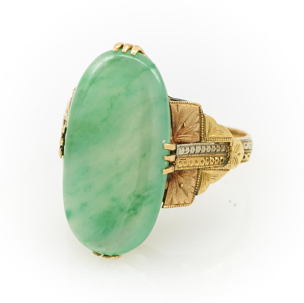 14k Tri-toned gold & jade ring: 14k Tri-toned gold and jade ring, an appx. 11mm x 21mm translucent jade cabochon prong set in an engraved retro setting, size 7.25, 5.8g.