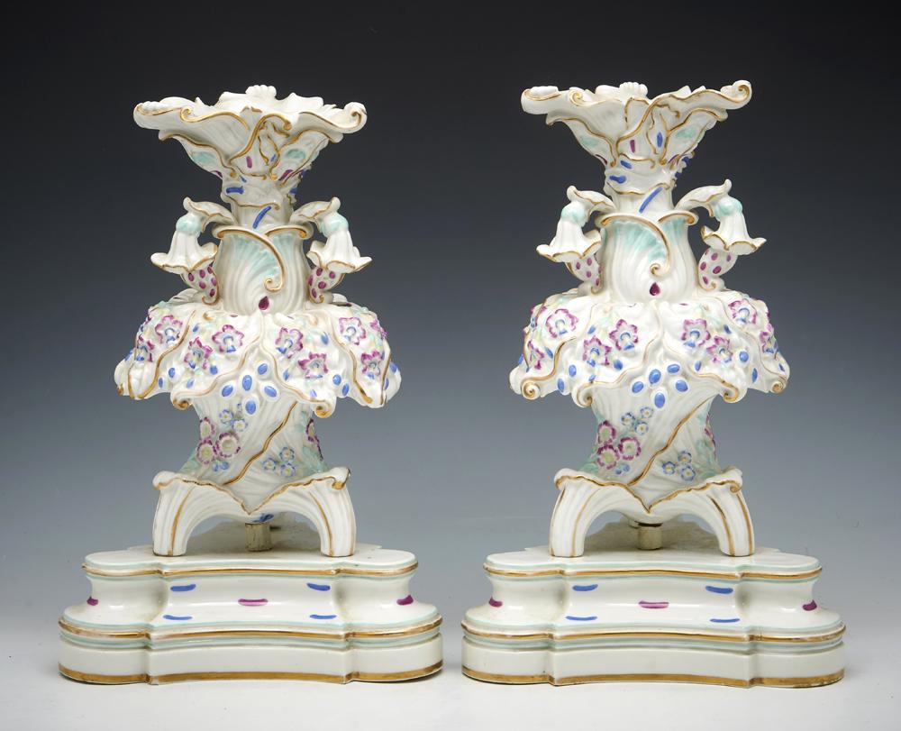 Pair of Jacob Petit elaborate porcelain tripod epergnes: Pair of Jacob Petit elaborate porcelain tripod epergnes on triangular bases in floral motif, gilt detailing, marked "JP" inside bases. Appx 15"h. Very good condition.