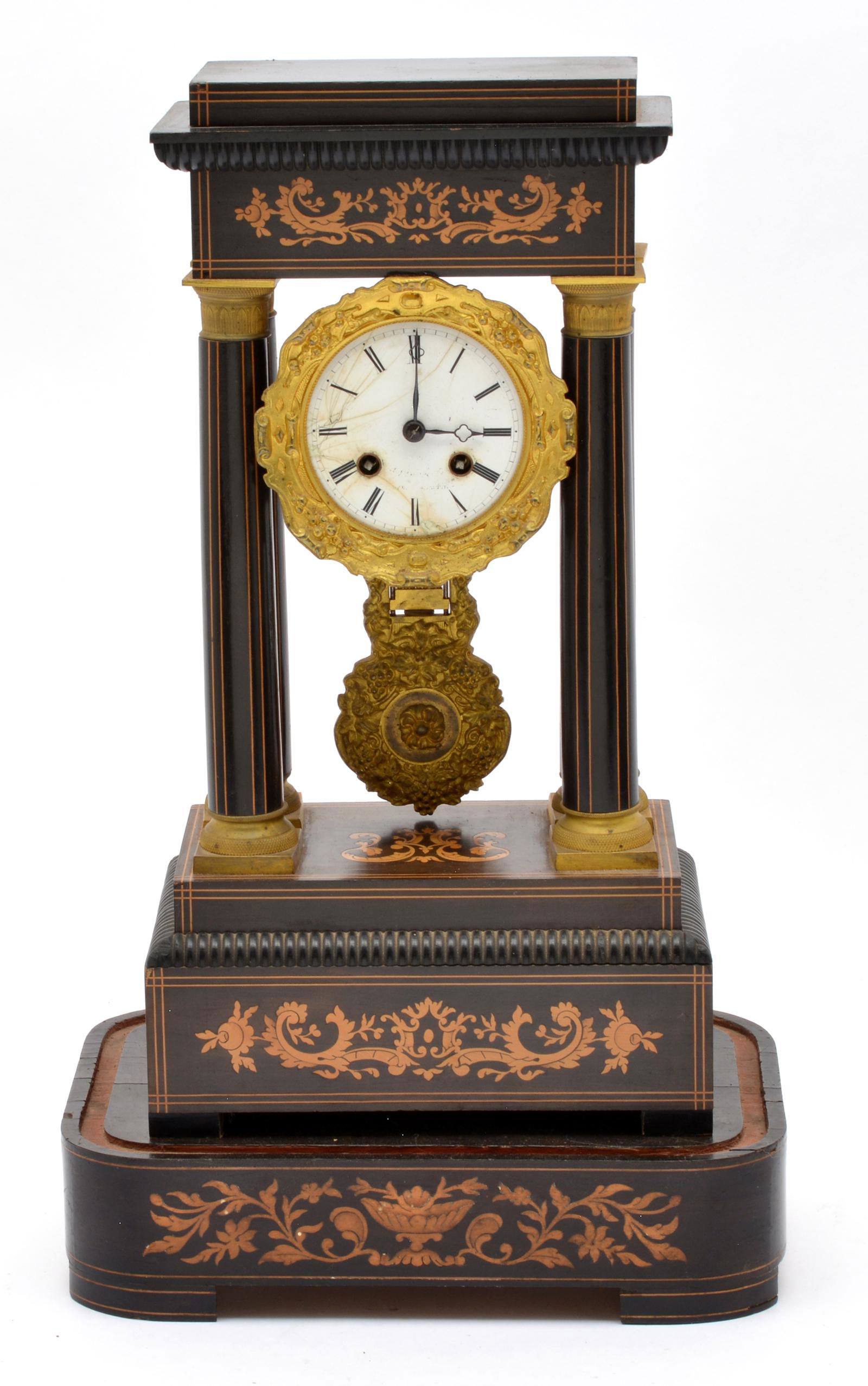 French Portico Clock on Stand.: French Portico Clock on Stand. Fancy brass dial surround, pendulum and column capitals. Inlaid case and base (lacking dome). Old cracks to enameled dial. Case: 16 1/2"t x 9"w x 6 1/2"d. Base 2 3/4"t.