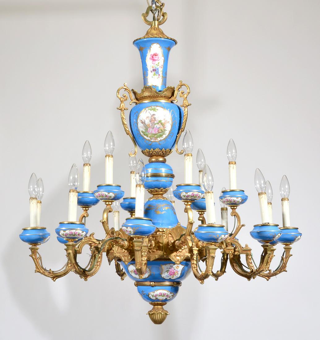 Sevres style porcelain and bronze 18-light chandelier: Sevres style porcelain and bronze 18-light chandelier, 20th c., blue and white with floral and figural panels, 40"h x 34 1/2"dia. Very good condition.