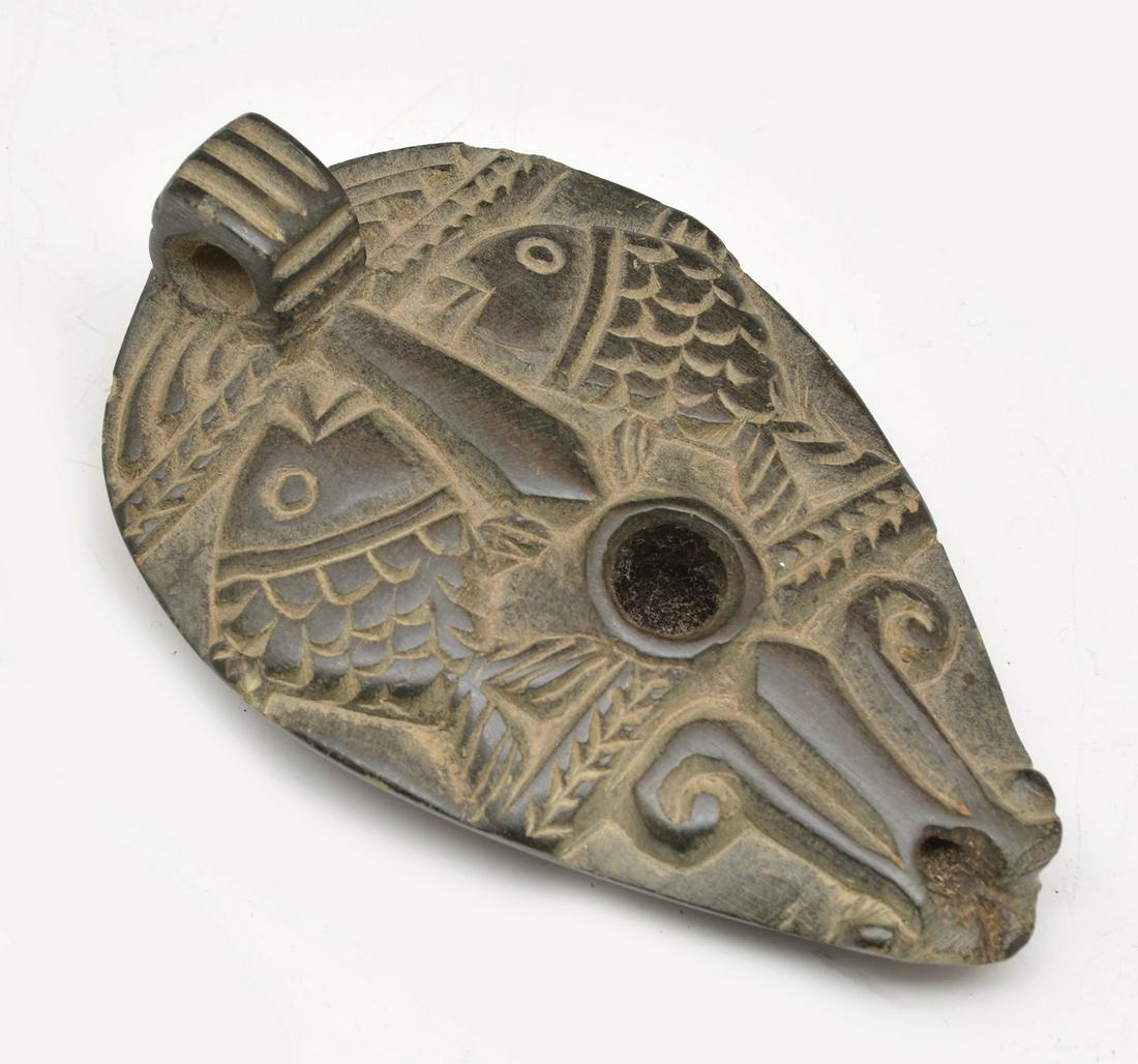 Ancient black stone oil lamp decorated with fish (1 of 3)