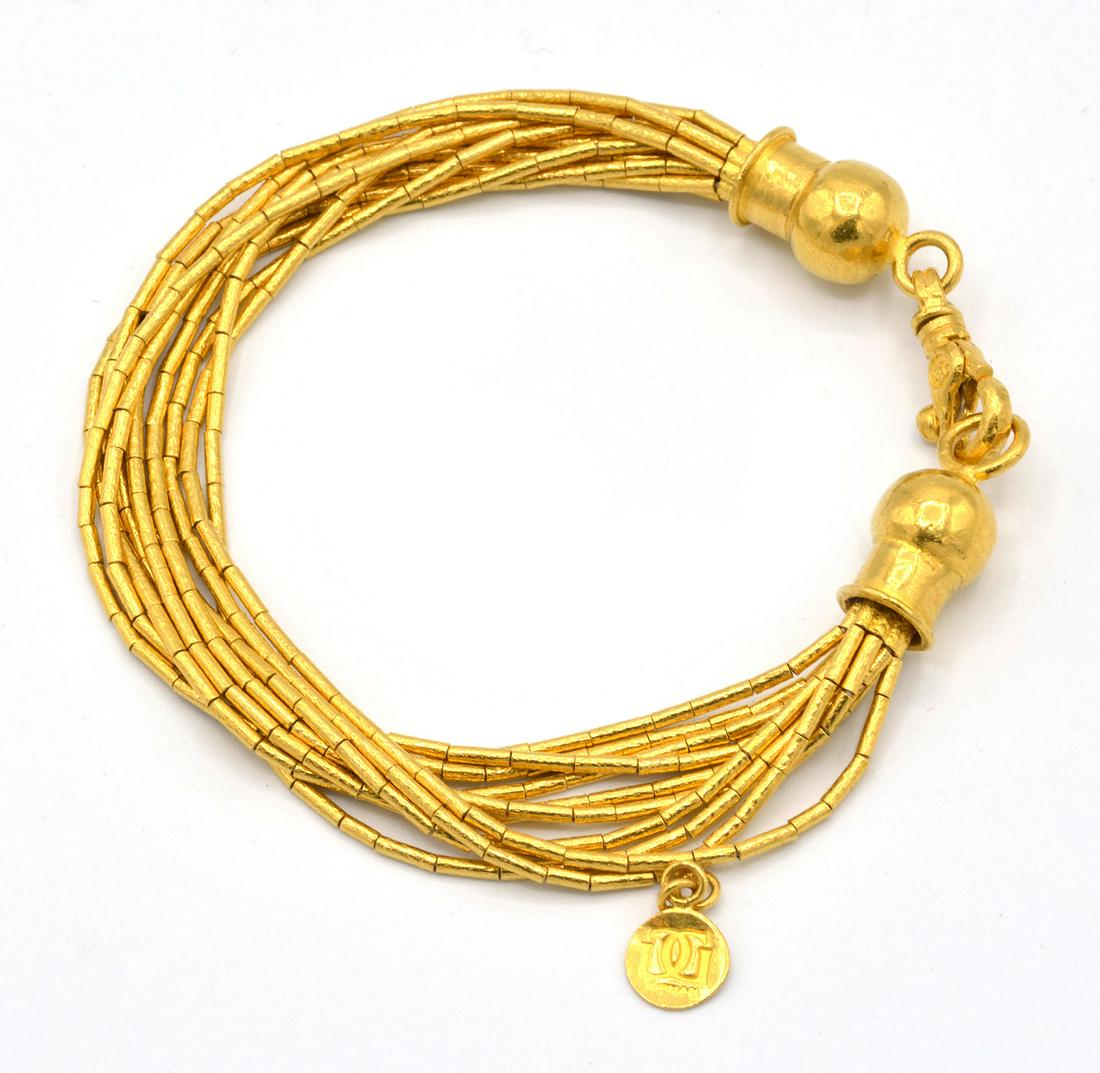 23K Gold Gurhan Ten Strand Bracelet: 23K Gold Gurhan Intertwined 10 Strand Bracelet with small signed disk. Appx. 7 1/4" long. 27.2g.