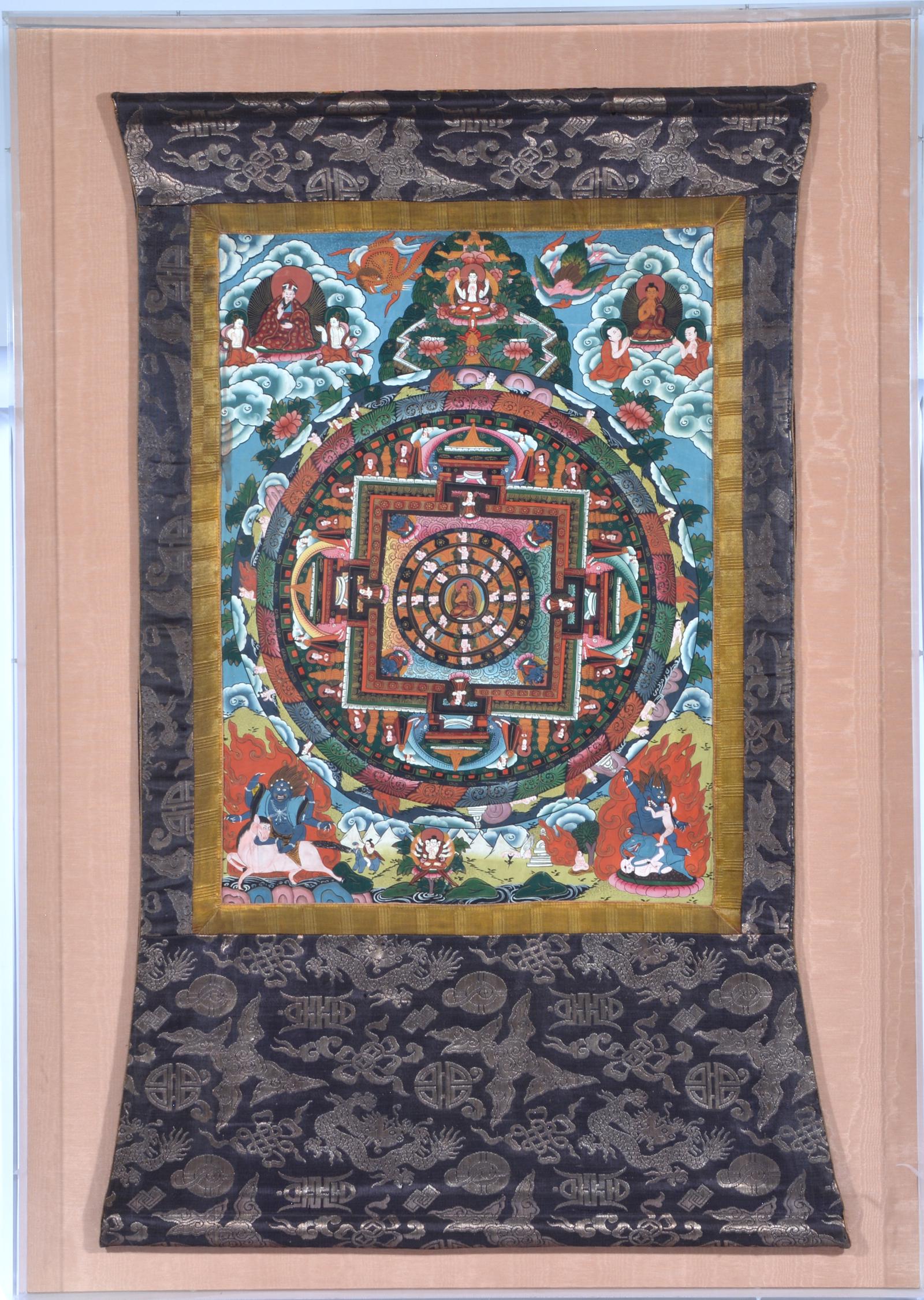 Thangka on textile scroll mounted in plexiglass frame: Thangka on textile scroll mounted in plexiglass frame with colorful figural vignettes. Thangka: approximately 45"t x 28"w; frame: 52" x 36 1/2". Very good condition.