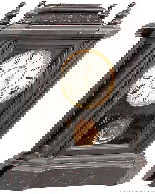 Ingraham 'The Domino' Clock: CLOCK. Ingraham Clock Co. "The Domino" model. Black case cottage style case. Eight day, time and strike. Circa 1900. Label on back. 15 3/8" H.