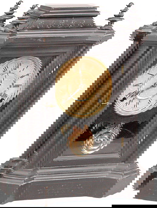 Ingraham 'The Domino' Clock: CLOCK. Ingraham Clock Co. "The Domino" model. Black cottage style case. Eight day, time and strike. Circa 1900. Label on back. 16" H.