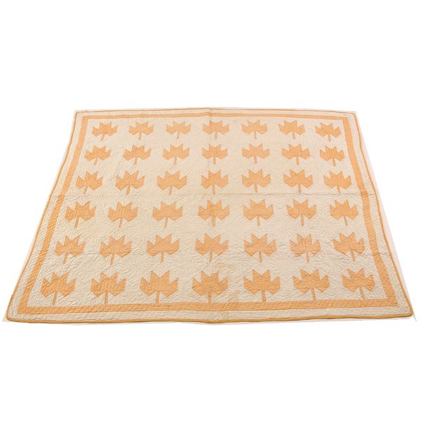 Vintage American Quilt, Yellow Maple Leaves: QUILT. Vintage American quilt with squash yellow maple leaves and frame on a muslin ground worked with sunflowers, good condition, light spotting in one area, 63" w x 70" l.