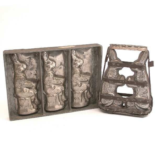 Two Vintage Chocolate Molds, Bunnies: MOLDS. Two vintage chocolate molds, the first hinged with three seated bunnies in overalls, the other with two bunnies holding Easter eggs, good condition, largest 14" w x 10" t.