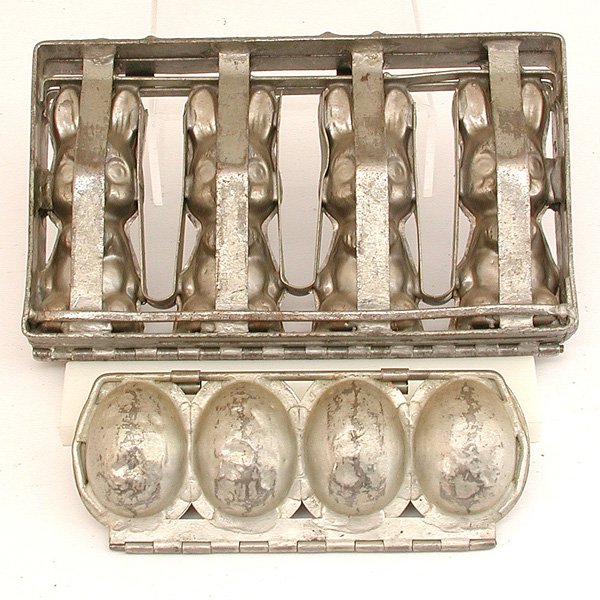 2 Hinged Chocolate Molds, Eggs & Bunnies: MOLDS. Two vintage chocolate molds, the first with four large eyed bunnies, the second with four Easter eggs, good condition, largest 13" w x 7 1/2" t.