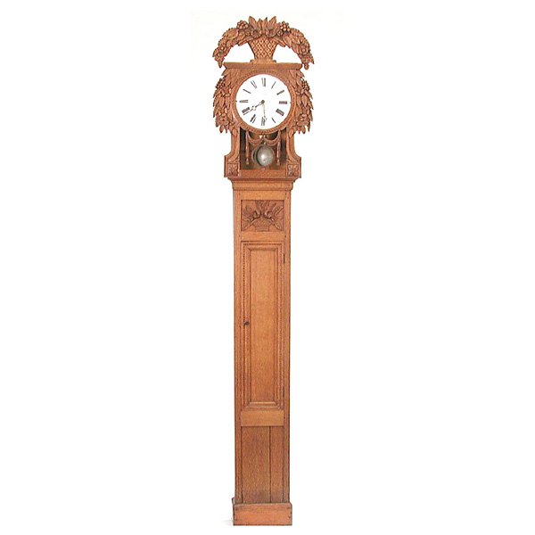 19th C French Oak Cased Wedding Clock: CLOCK. 19th century French oak cased wedding clock, the enamel clock face marked Decaux a St. Nicholas, enclosed by a narrow case that is topped with a carved basket of flowers, a harvest wreath aroun