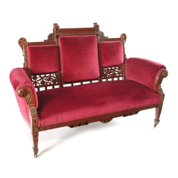 Victorian Walnut Renaissance Revival Couch: COUCH. Victorian walnut Renaissance revival couch with ebonized and gilt detail, openwork carving, upholstered in burgundy velvet, original finish, good condition, 65" l.