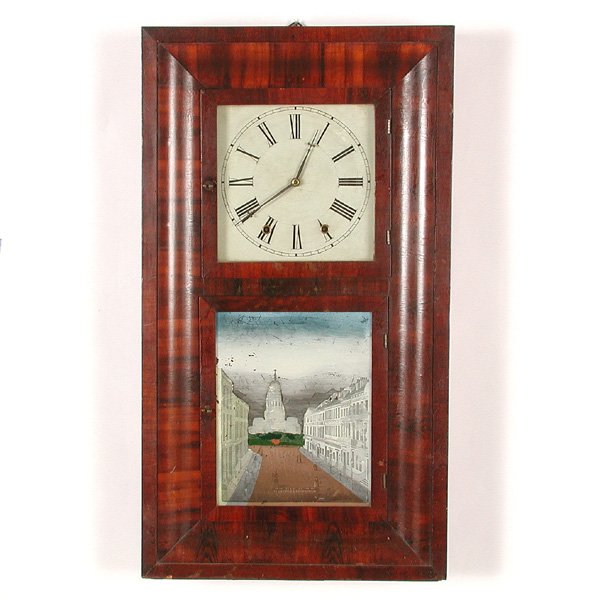 251. American Mahogany Ogee Clock, 19th. C: CLOCK. American Mahogany Ogee Clock, the case banded in intensely varied high tone grain, the upper window with a Roman numeral dial, the lower window with transfer and painted reverse glass picture o