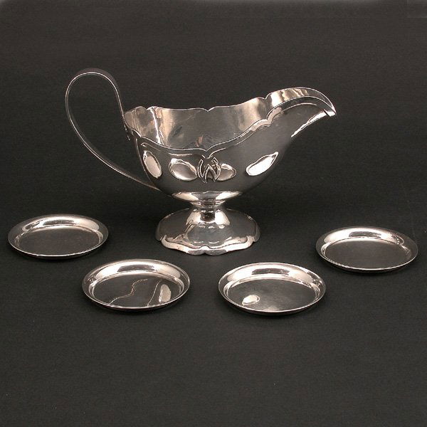 Shreve & Co. Hand Wrought Sterling Gravy: GRAVY. Shreve and Co. hand wrought sterling silver gravy boat with a hammered handle and raised trim, together with four Porter Blanchard sterling coasters of simple design, good condition, gravy 8" w