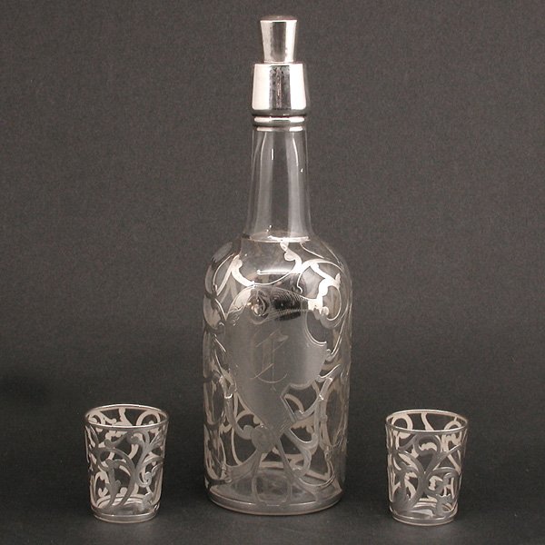 Sterling Silver Overlay Decanter & 2 Cordials: DECANTER. Glass decanter decorated with sterling silver overlay fashioned as twining vines, together with two matching cordial glass, very good condition, decanter 11 3/4" t, cordial 2 3/8" t.