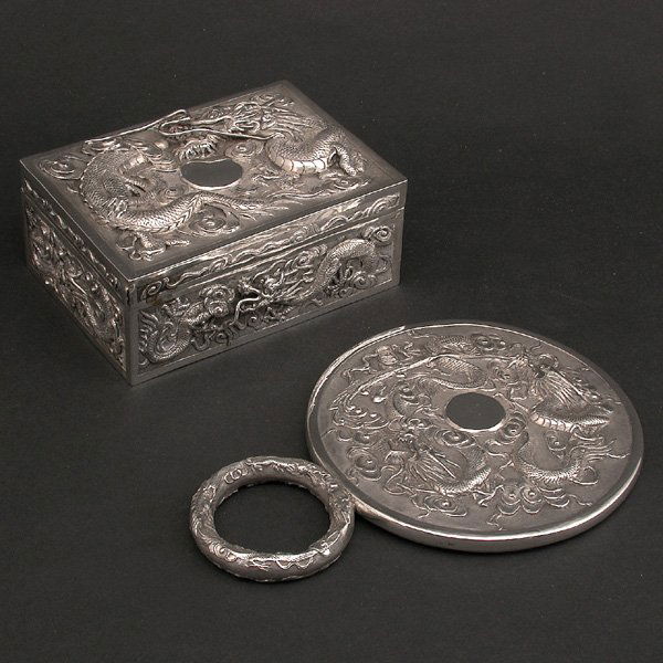 2 Pcs. Chinese Silver; Box & Mirror: SILVER. Two pieces of Chinese silver consisting of; a box with raised decoration of dragons on the top and sides together with a beveled hand mirror with silver back, also decorated with dragons, good
