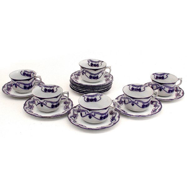 English Flow Blue Cups & Saucers, 18 Pcs.: PORCELAIN. English flow blue porcelain in the "Paris" pattern with a sinuous art nouveau design, twelve saucers, eight cups, good condition, one cup repaired, saucer 5 3/4".