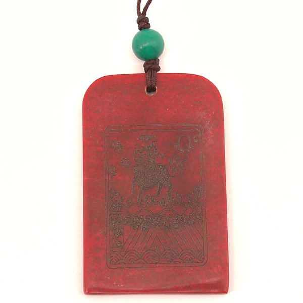 Chinese Chicken's Blood Stone Pendant, 19th C: PENDANT. Chinese "Chicken's Blood" pendant of rectangular shape with curved corners at the top, both sides are incised with "Chiling" the mythical beast above crested waves and mountain peaks, the sto