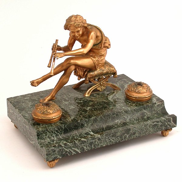French Dore Bronze & Marble Inkwell, Pan: SCULPTURE. French dore bronze and marble sculptural inkwell, the vert marble platform base set with two highly chased inkwells with leaves and flowers and a center opening for fountain pens, seated be