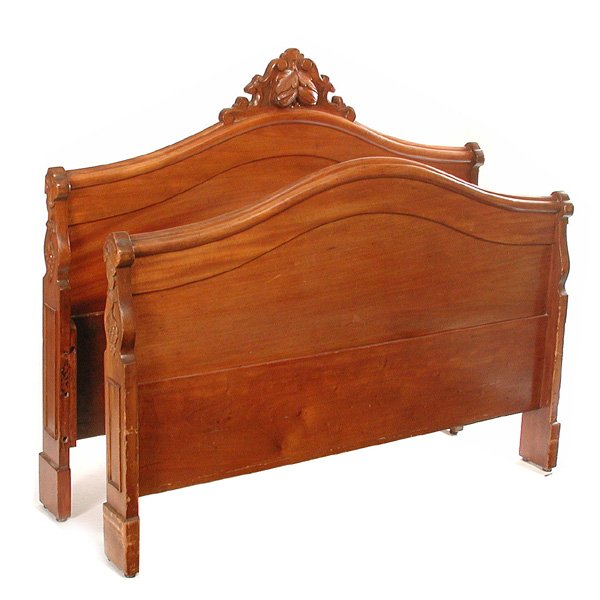 Victorian Walnut Bed, Carved Crest: BED. Victorian walnut bed with arched headboard and footboard, the headboard with a carved crest centered by leaves and nuts, good condition, 57 1/2" w x 49" t.