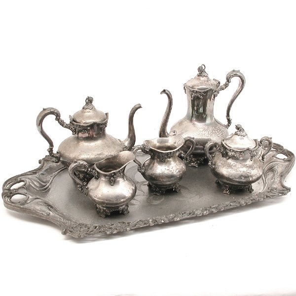 Art Nouveau Platter Together W Tea Set, Silver Pla: TEA SET & PLATTER. Seven piece grape handled silverplate tea set; tea pot, coffee pot, two creamers, one sugar, one waste, misc. lid together with a large art nouveau silver plated tray, with an iris 