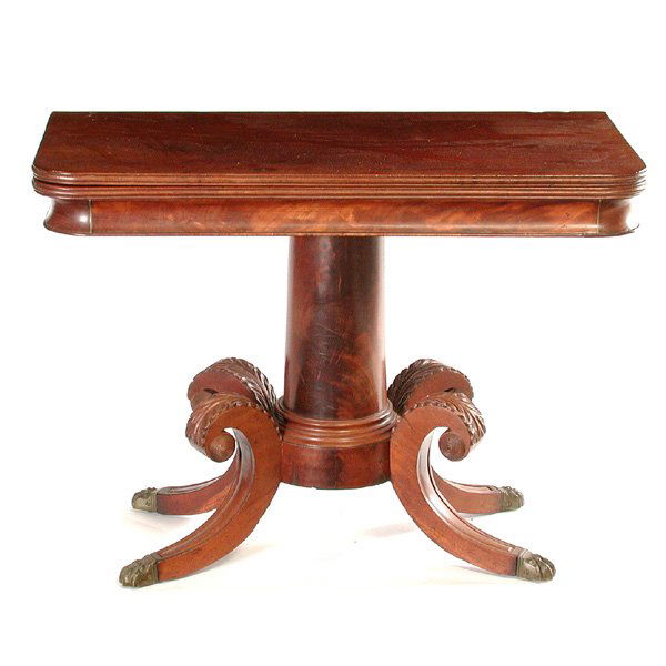 Duncan Phyfe Games Table, E 19th. C.: TABLE. Early 19th. century English Mahogany Duncan Phyfe games or tea table with flip top edged with reeding, the apron and circular column support are highly figured and end in four vibrantly scrolle