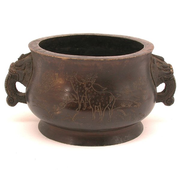 Chinese Incised Bronze Censor, 'Qin Su Lu' Mark: CENSOR. Chinese Incised Bronze Censer, "Qin Su Lu" mark, with round sides and a pair of lion-like mythical animal head handles, the whole supported on splayed foot, the body incised with deers in a ga