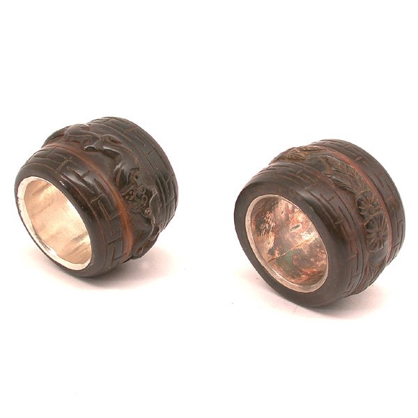 Chinese Rhinoceros Horn Archer's Rings, Qing: ARCHER RINGS. Chinese carved Rhinoceros horn Archer's rings, each of cylindrical form with silver lined interior, one carved with intertwined bats around the middle and framed by keyfret bands around 