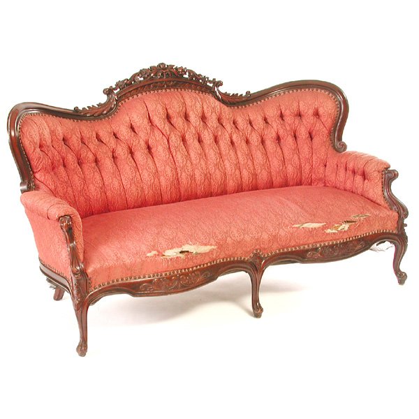 Victorian Walnut Settee: SETTEE. Victorian walnut settee having carved floral and acanthus leaf crest, tufted back, serpentine front, rising on five carved legs, 39"h x 70"w x 29"d, in good condition, but in need of re-uphols