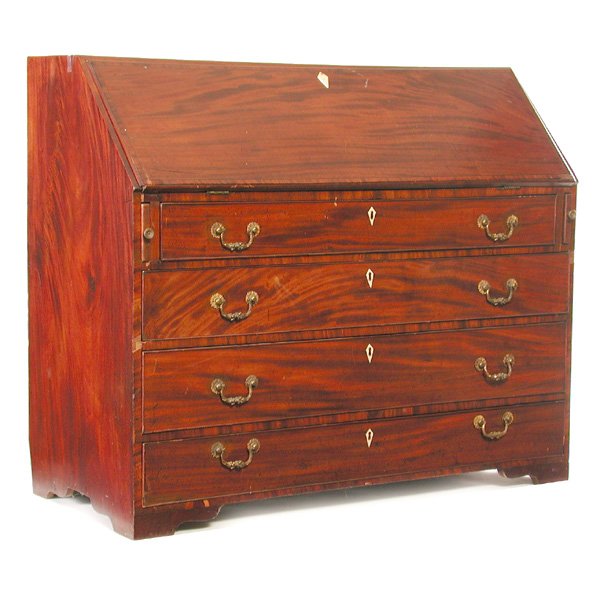 Mahogany Atlantic Coast Chippendale Desk: DESK. Flame mahogany Atlantic coast Chippendale slant lid desk having graduated drawers with ivory escutcheons, the lid drops to reveal a fine bird's eye maple interior, on bracket base, 40"h x 47 1/2