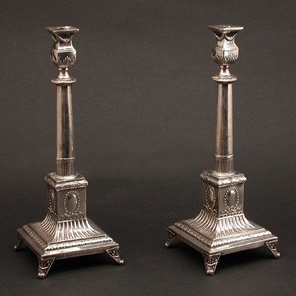 Adams Style 800 Fine Polish Silver Candlesticks: CANDLESTICKS. Pair of 800 fine Polish silver Adams style candlesticks, circa 1920, having squared bobeches and columnar supports with stop fluting, the bases with cabochon reserves and foliate detaili