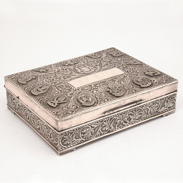 Malaysian Silver Presentation Box: BOX. Silver Malaysian presentation cigar box, ornately decorated, centered with the National Emblem of Malaysia having armorial flanked with a pair of rampant tigers and a banner below stating 'Unity 