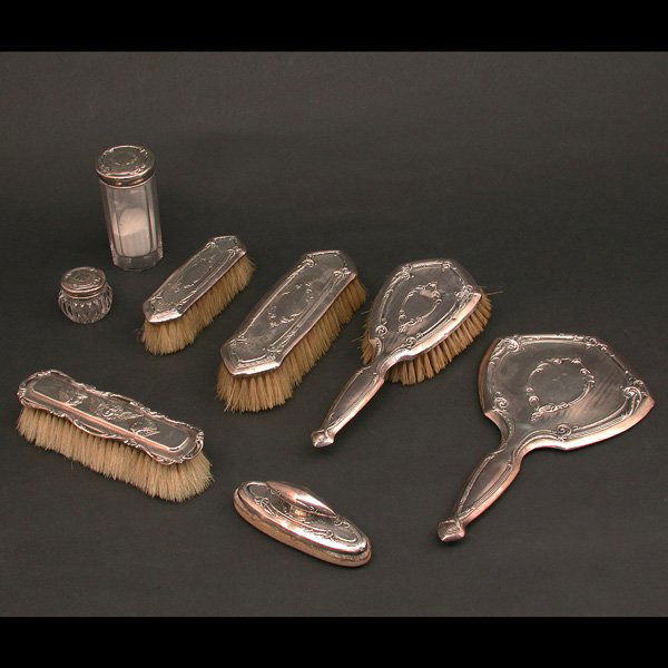 Sterling Silver Dresser Set: DRESSER SET. American sterling silver dresser set including two clothes brushes in graduated sizes, hair brush, hand mirror, nail buffer, powder jar, and pin jar, together with an associated sterling