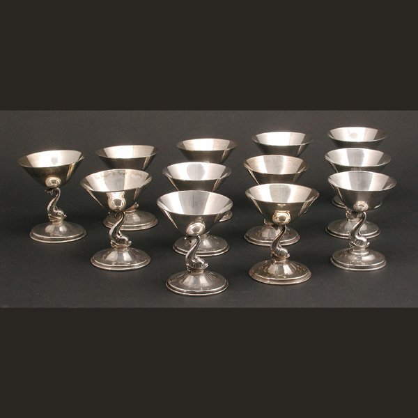 Mexican Sterling Sherbets: SHERBETS. Set of twelve Mexican sterling sherbets by Jose Marmolejos, Mexico City, having dolphin form stems and circular bases, bearing eagle 32 hallmark and maker's mark to base, 4"h x 3"d, 60 troy 