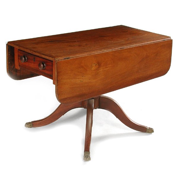 Antique Duncan Phyfe Style Table: TABLE. Duncan Phyfe style drop-leaf mahogany dining table comprised of period elements, having single board top and rounded end drop leaves above frieze drawer apron, rising on a turned standard with