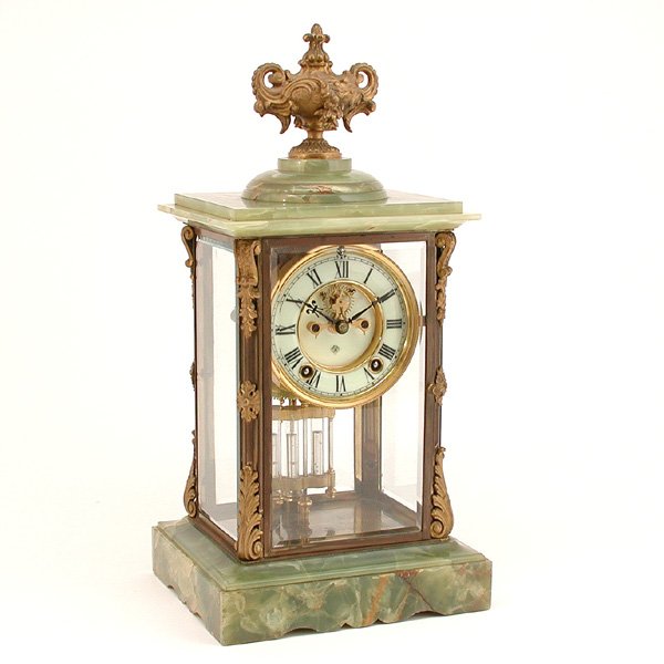 Ansonia Brazilian Green Onyx Regulator Clock: CLOCK. Ansonia Brazilian green onyx crystal regulator clock, having an ormolu urn form finial, beveled glass sides flanked with ormolu acanthus leaf mountings and containing mercury tube pendulum, wit